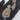 Gold-tone CZ pendant with green centre stone, ruby-pink border and leaf motif, with matching earrings