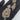 Gold-tone CZ pendant with green centre stone, ruby-pink border and leaf motif, with matching earrings
