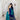 Model wearing pure Gajji silk bandhani saree in teal green and royal blue with gold tissue pallu and white lace border