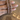 Antique gold bangles with rani pink stones held by a jewelry model