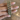 Antique gold bangles with emerald green stones held by a jewelry model