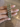 Antique gold bangles with emerald green stones held by a jewelry model