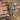 CZ bangles with emerald green oval stones held by a jewelry model