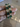 Emerald green cushion stone CZ bangles held by a jewelry model