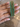 Set of four slim emerald green CZ bangles held by a jewelry model