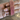 Set of four slim ruby pink CZ bangles held by a jewelry model