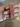 Set of four slim ruby pink CZ bangles held by a jewelry model