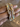 Angled view of pastel stone mirror-square bangles held by a jewelry model