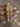 Gold jali kundan bangles with ruby and emerald stones held by a jewelry model