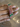 Ruby baguette bangles with emerald oval accents held by a jewelry model