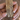 Baguette mosaic CZ bangles in gold tone held by a jewelry model