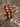 Red meenakari kundan bangles with pearl flowers held by a jewelry model
