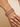 Model wearing antique gold rani pink stone bangles on her wrist