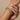 Model wearing antique gold emerald green stone bangles on her wrist
