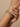 Model wearing antique gold emerald green stone bangles on her wrist