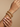 Model wearing gold jali kundan pearl white bangles on her wrist