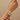 Model wearing gold tone baguette mosaic CZ bangles on her wrist