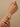 Model wearing gold tone baguette mosaic CZ bangles on her wrist