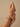 Model wearing ruby baguette bangles with emerald accents on her wrist