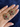 Antique gold flower stud earrings with multicolor semi-precious stones held in hand