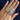 Stack of slim silver-tone textured metal bangles held in hand