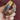 Angled view of Jaya multicolor meenakari enamel bangles showing gold floral patterns and crystal-studded edges