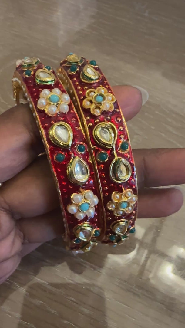 Video of red meenakari kundan bangles with pearl flowers showing vivid colour