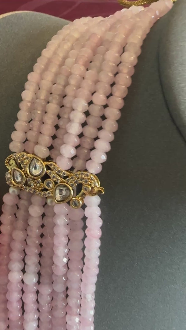 Video of the rose quartz 7-strand beaded mala with kundan accents, soft background music