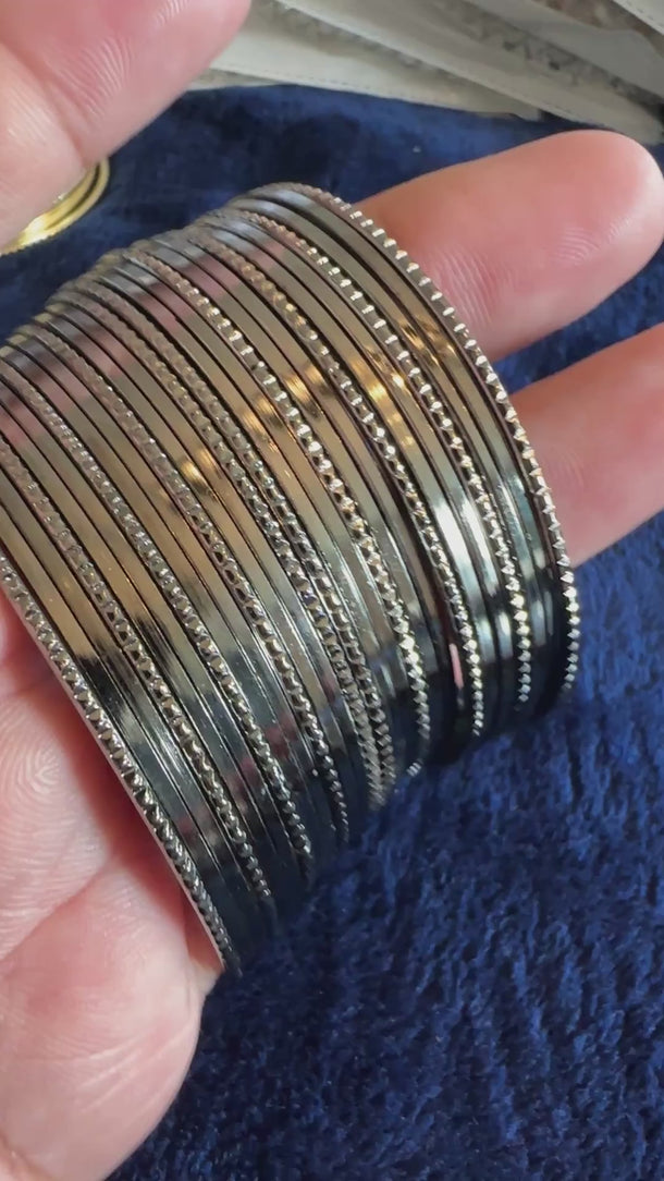 Video of the gunmetal textured metal bangle stack with soft background music