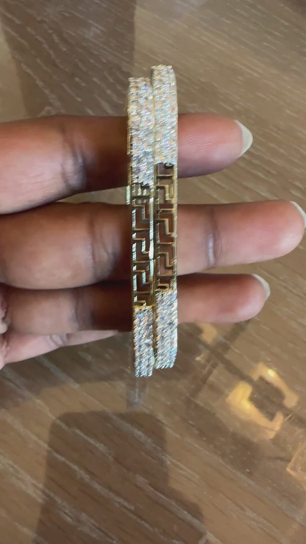 Video of Greek key CZ bangles in gold tone showing the cutout pattern and sparkle