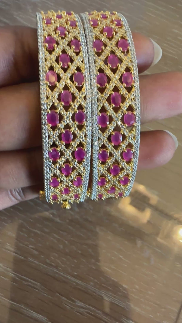 Video of ruby red lattice broad kada bangles showing woven pattern and sparkle
